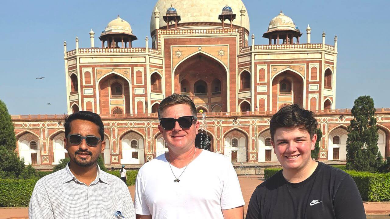 Three travelers standing in front of Humayun’s Tomb in Delhi during the Golden Triangle Tour with Jhansi and Orchha