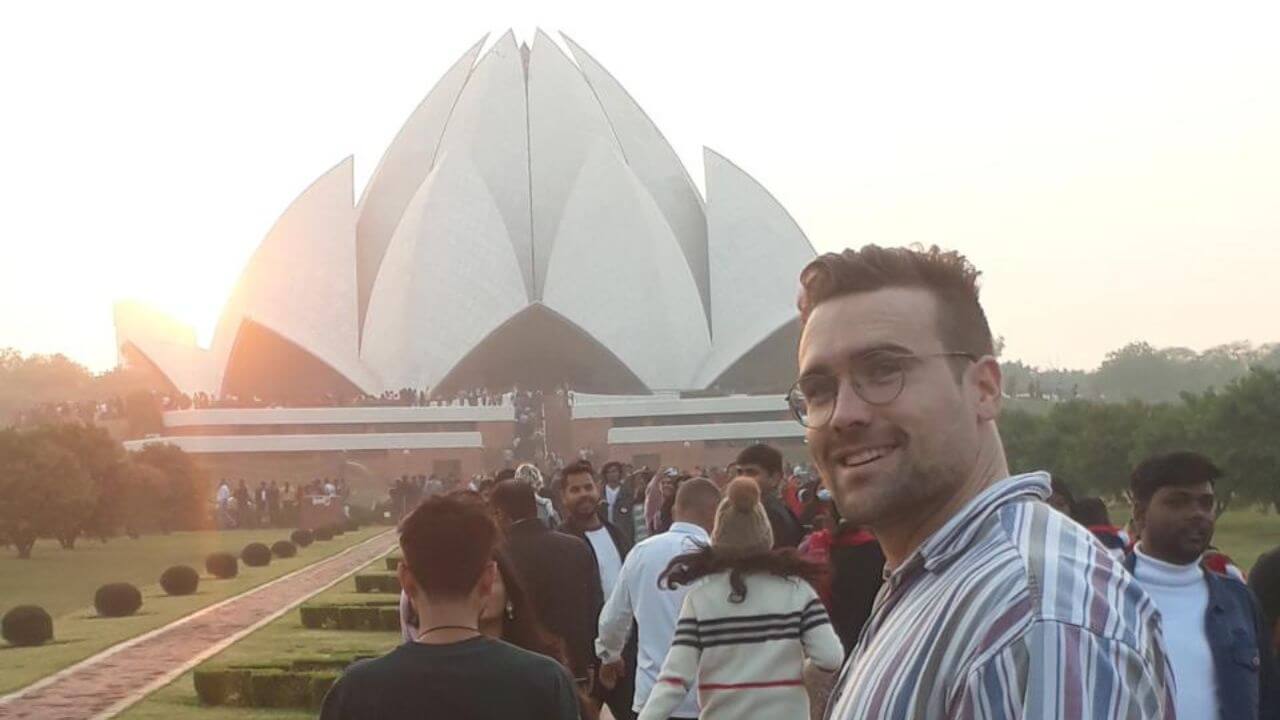 International traveler walking toward the Lotus Temple at sunset during the Golden Triangle with Rishikesh tour in Delhi