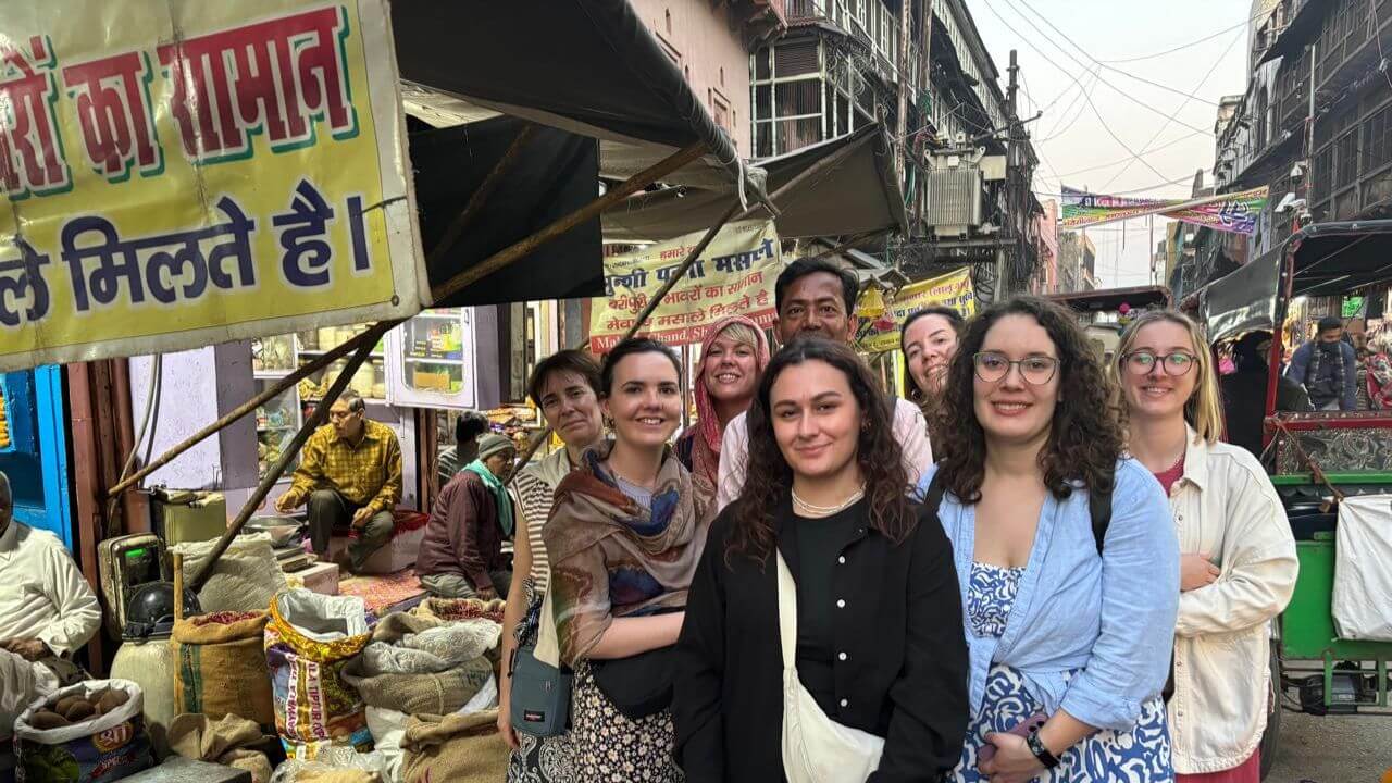 A group of women tourists on a guided walk through Old Agra’s bustling spice market during the Hidden Gems Heritage Walking Tour.