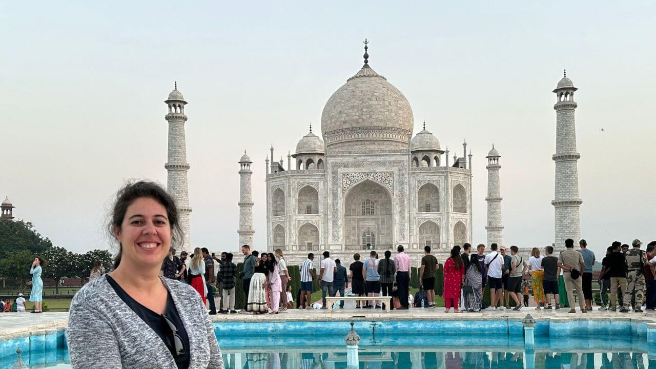Female traveler sitting by the Taj Mahal reflection pool during the Sunrise Taj Mahal Tour from Delhi